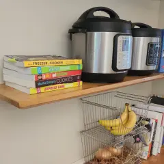 DIY floating shelves hold Instant Pots, cookbooks, and bananas.