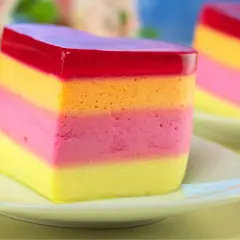 Kolorowa galaretka z mlekiem skondensowanym, warstwowa jak tęcza, kusi smakiem.