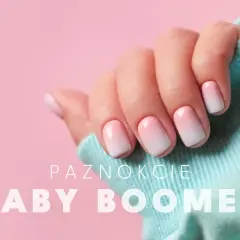 Dłoń z paznokciami w stylu baby boomer, delikatny gradient różu i bieli.