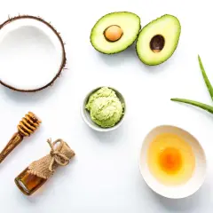 Ingredientes para una mascarilla casera para el pelo: aguacate, coco, aloe vera, miel y huevo.