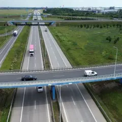 Widok z lotu ptaka na wielopoziomowy węzeł autostradowy z ruchem samochodowym i ciężarowym.