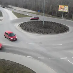 Rondo turbinowe jak jeździć: czerwone samochody płynnie poruszają się po rondzie, pokazując zasady ruchu.