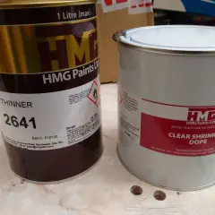 Deux boîtes de peinture HMG, l'une de diluant, l'autre de dope rétractable.