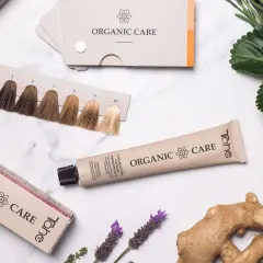 Paleta de tonos para la pigmentación del cabello, tubo de tinte y caja de "Organic Care" con ingredientes naturales.