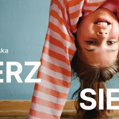 Uśmiechnięta dziewczynka w pasiastej bluzce robi mostek. Logo Erste Group i hasło "WIERZ W SIEBIE" zachęcają do wiary we własne możliwości.