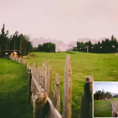 Darmowe presety Lightroom ożywiają krajobraz z drewnianym płotem i chatką w górach.