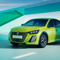 Nowe samochody do 70 tys. zł: jaskrawozielony Peugeot 208 na tle nowoczesnej architektury i krajobrazu.