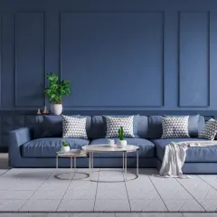 Nowoczesny salon w odcieniu głębokiego, **kolor petrol jaki to** granatu. Duża, wygodna kanapa, stoliki kawowe i dekoracje tworzą przytulną atmosferę.