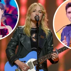 Trzy osoby na scenie: kobieta gra na gitarze, kobieta w czerwieni trzyma nagrodę, mężczyzna z wąsami trzyma nagrodę.