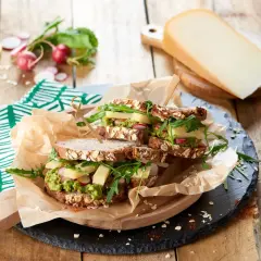 Une idée de sandwich gourmande : pain aux céréales, avocat, fromage, radis et roquette. Parfait pour un repas sain et savoureux.