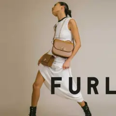 Modelka w białej sukience prezentuje dwie brązowe torebki Furla, symbol tanich włoskich marek.