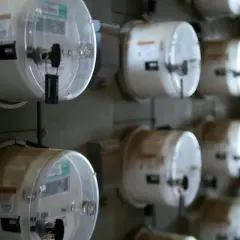 Rząd liczników energii elektrycznej, gotowych do odczytu. Dowiedz się, jak przepisać licznik Enea.