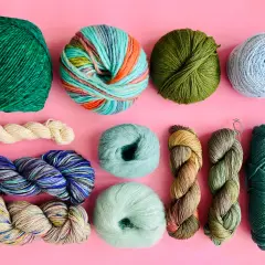 Assortiment de pelotes de laine aux couleurs vives et naturelles, évoquant l'origine de la laine et la beauté de la nature.