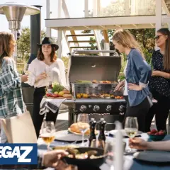People enjoying a barbecue on a sunny patio with a Bluegaz Z1 grill.