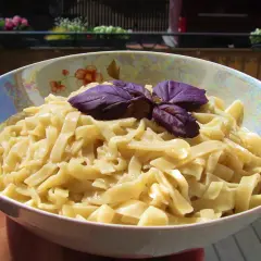 Pyszny makaron strozzapreti, idealny do prostego przepisu. Udekorowany fioletową bazylią, czeka na sos.