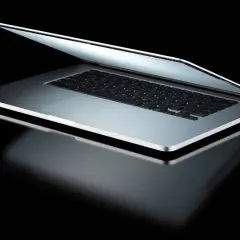 Elegancki laptop z otwartą klapą, odbijający światło. Dowiedz się, jak sprawdzić model laptopa, by poznać jego specyfikację.