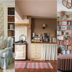 A cozy modern English cottage interior with a striped armchair, a vintage stove, and a wall of books.