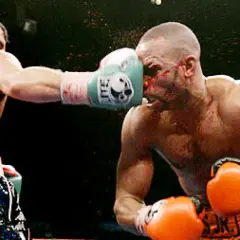A boxer lands a punch on his opponent's face during the Joe Calzaghe vs Roy Jones Jr. fight.