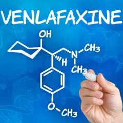 Rysunek chemiczny wenlafaksyny, leku znanego też jako velaxin, na niebieskim tle z wzorami chemicznymi.