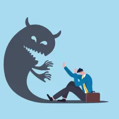 Przerażony mężczyzna w garniturze siedzi na ziemi, gdy cień potwora z rogami i zębami zbliża się do niego. Może to symbolizować problemy z firmą outsourcingową.