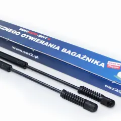 Dwa siłowniki do automatycznego otwierania bagażnika, zapakowane w niebieskie pudełko z napisem "MADE IN POLAND".