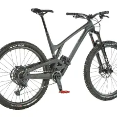 A dark grey Evil Offering mountain bike, ready for an evil offering review. Features Maxxis tires and red pedals.
