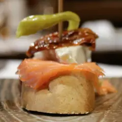 Pinchito con salmón, queso, pimiento y anchoa. Una deliciosa muestra de los tipos de guindillas españolas.
