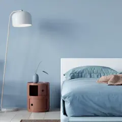 Ein hellblaues Schlafzimmer mit einem Bett, einem Stuhl und einem Nachttisch. Die schlafzimmer farbgestaltung wirkt beruhigend und modern.