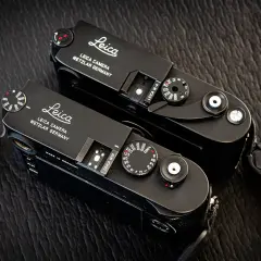 Two black Leica M cameras, ready for detailed Leica lenses reviews.