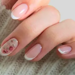 Delikatne paznokcie ślubne boho z subtelnym zdobieniem w postaci różowych kwiatów na jednym z paznokci. Klasyczny french manicure w nowoczesnym wydaniu.