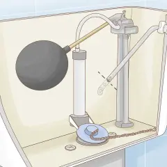 Diagram of a toilet tank's internal mechanism, showing the float ball, fill valve, and flush valve. The lever arm for the toilet handle appears loose.