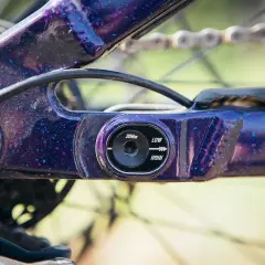 Close-up of a purple speckled flip chip mtb frame, showing adjustment settings for geometry.