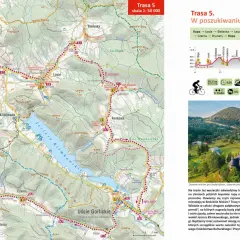 Mapa turystyczna Beskidu Niskiego z zaznaczoną trasą rowerową "W poszukiwaniu ropy". Widok na malownicze **beskid niski szczyty** i zabytkową cerkiew.
