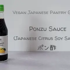 A bottle of Yuzu Organic Ponzu sauce, a tangy Japanese citrus soy sauce, is featured in this vegan pantry guide.