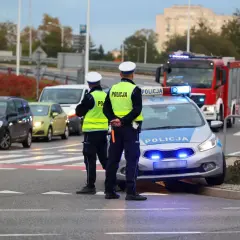 Policjanci kontrolują ruch po wypadku. Sprawdzają, czy kierowcy nie przekroczyli dopuszczalnych promili alkoholu.