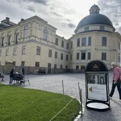 Besökare vid Drottningholms Slott, en plats känd för sin vackra arkitektur och historiska betydelse, kanske till och med Drottningholms opera.