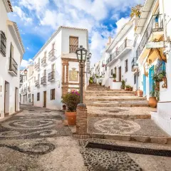 Calle empedrada con diseño de espirales, casas blancas y escalinata. Ideal para tu plan de qué ver en Andalucía en 7 días.
