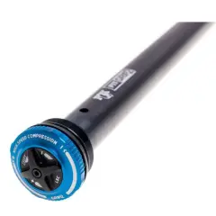 Close-up of a black bicycle suspension stanchion with a blue GRIP2 damper adjustment dial. The dial features "HIGH SPEED COMPRESSION" and "LSC" markings.