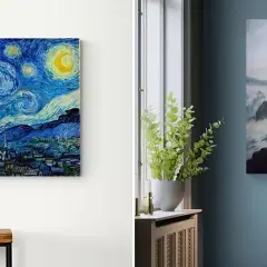 Reprodukcja "Gwiaździstej nocy" Van Gogha i obraz mężczyzny na skale na tle mglistych gór.