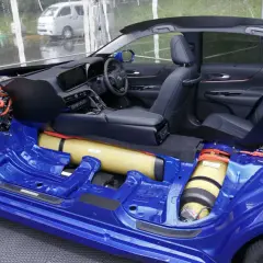 Sezione di un'auto a idrogeno blu, che mostra il telaio, i serbatoi di idrogeno e il motore elettrico.