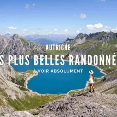 Vue panoramique d'un lac bleu turquoise entouré de montagnes majestueuses en Autriche. Une femme en robe blanche admire le paysage, prête pour un trek.