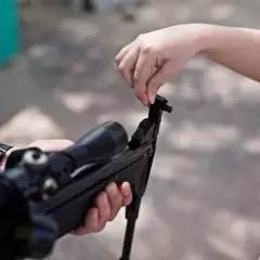 Dziecko uczy się, jak wygląda wiatrówka, manipulując jej mechanizmem.