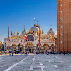 La place Saint-Marc à Venise, idéale pour visiter Venise en 3 jours. La basilique et le campanile se dressent sous un ciel bleu.