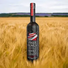 Butelka wódki Two Flags na tle złotego pola. Zastanawiasz się, ile kalorii ma setka wódki czystej?