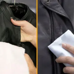 Entretien veste cuir : une main nettoie une veste en cuir noir avec un chiffon blanc.