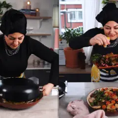 Kvinna i kök förbereder warak enab, fyllda vinblad med ris och grönsaker, och garnerar med granatäpple.