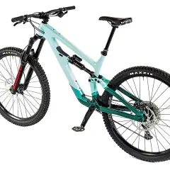 A teal and green full-suspension mountain bike, possibly a Salsa Cassidy, with Maxxis tires and a WTB saddle, ready for any trail.