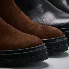 Bruna mockastövlar och svarta läderkängor med tjocka sulor. För att ta hand om skinnskor och mocka krävs rätt produkter.