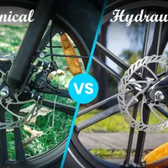 Comparing mechanical vs hydraulic disc brakes on bicycles. The left shows a mechanical brake with a cable, while the right displays a hydraulic brake system.
