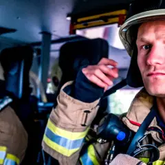 Zwei Feuerwehrmänner in voller Montur, bereit für den Einsatz. Die Serie "Feuer und Flamme Staffel 10" zeigt ihren Alltag.
